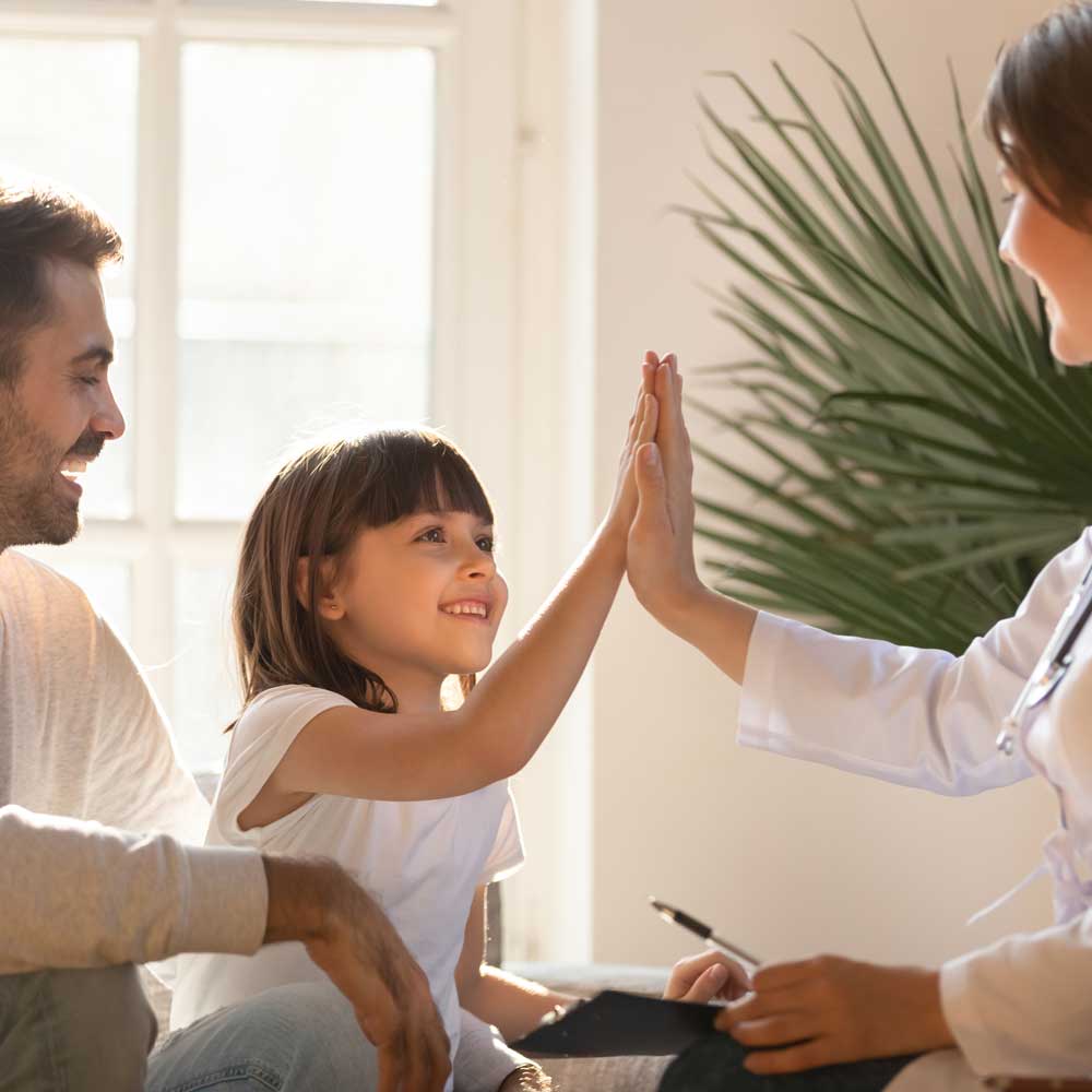 Young girl high-fiving a female pediatrician | Family care in Warwick, NY by Warwick Pediatric & Women's Health