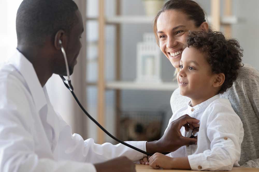 Male doctor listening to a young boy's heartbeat | Pediatric care in Warwick, NY by Warwick Pediatric & Women's Health